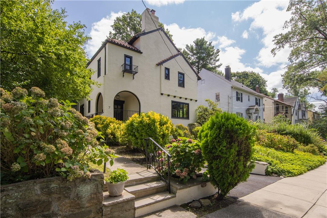 a front view of a house with a garden