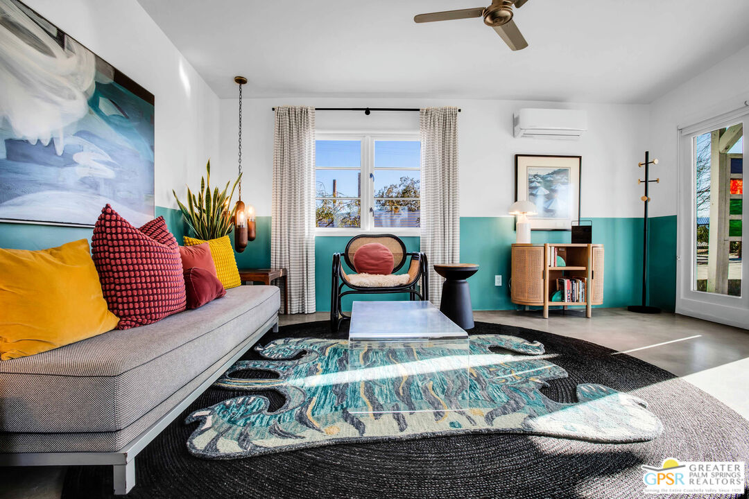 a living room with furniture and a rug