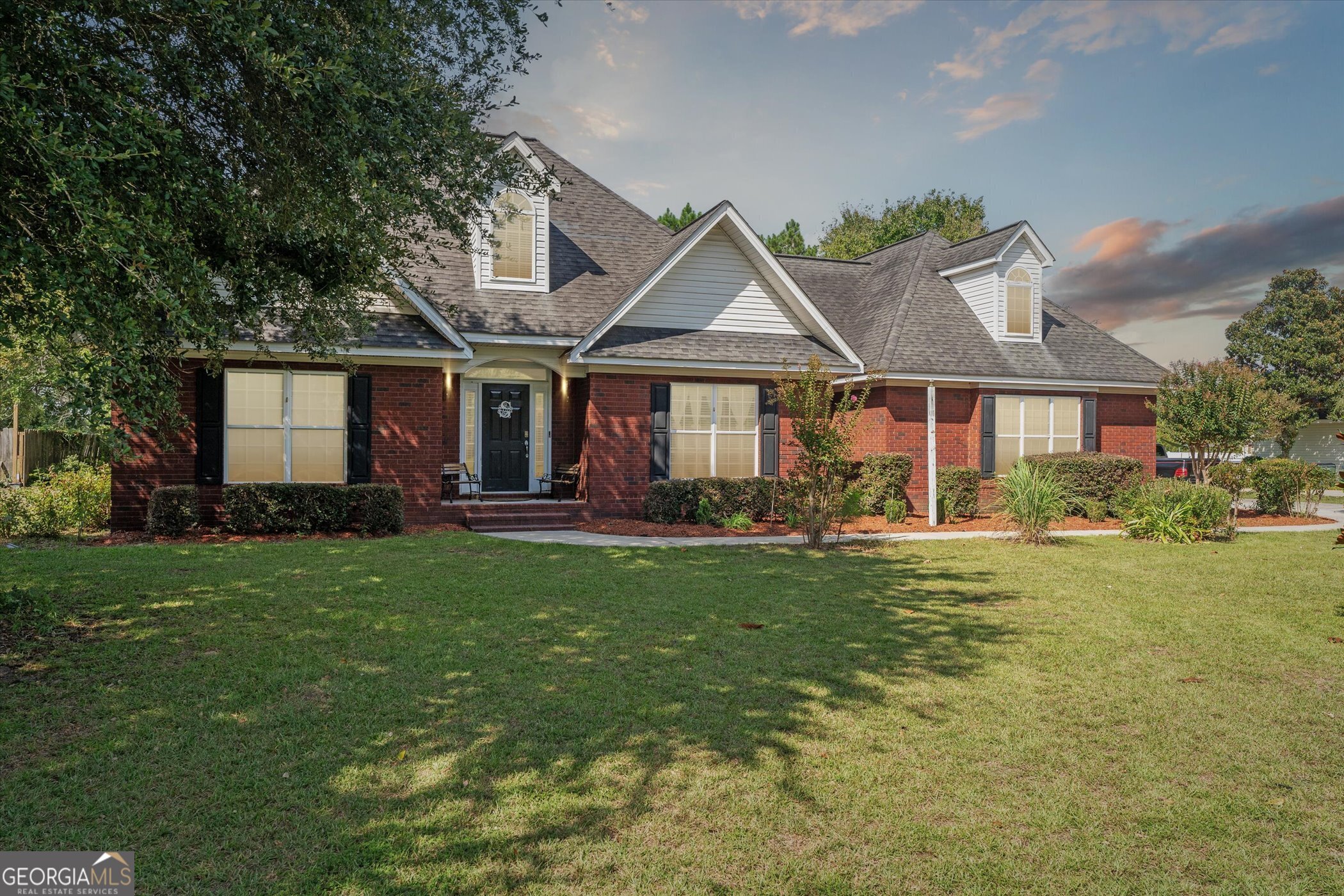 a front view of a house with garden