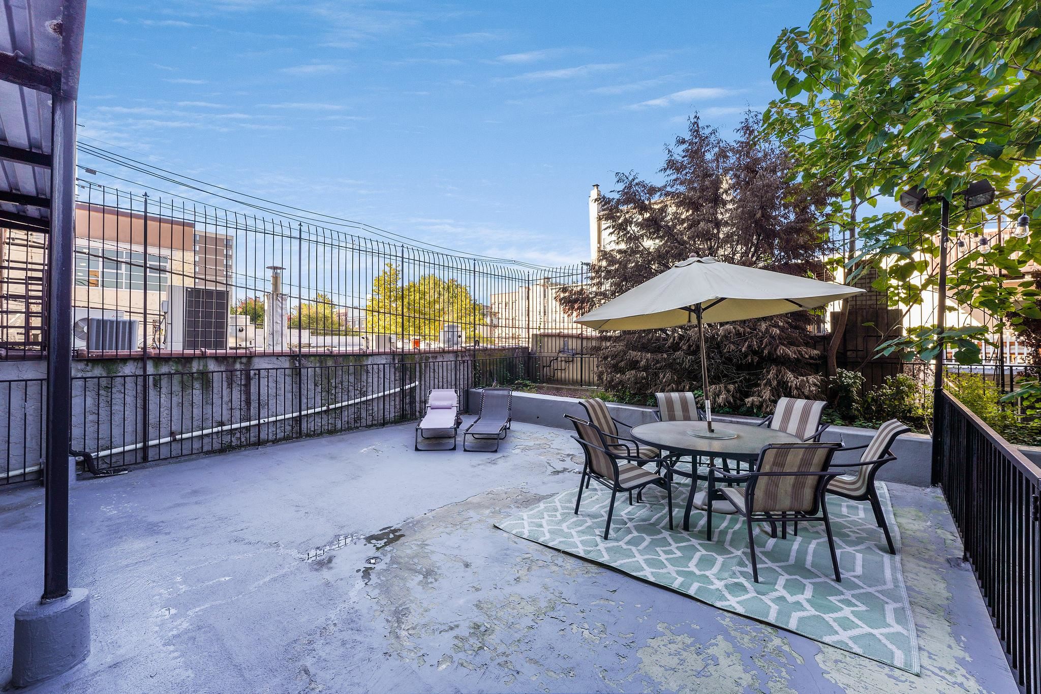 a view of a chairs and table in backyard