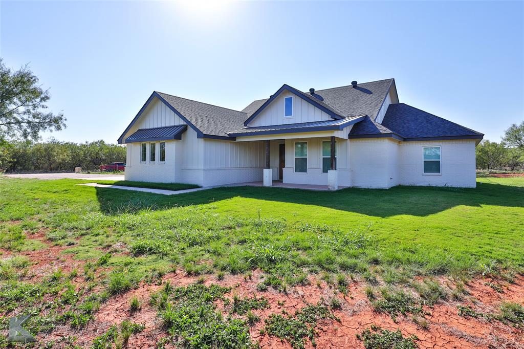 a front view of a house with yard and green space