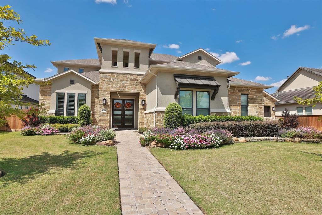 Stunning stone facade with manicured landscaping.