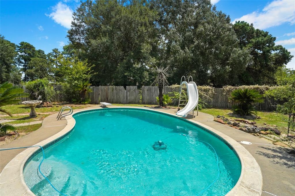 a swimming pool with outdoor seating and yard