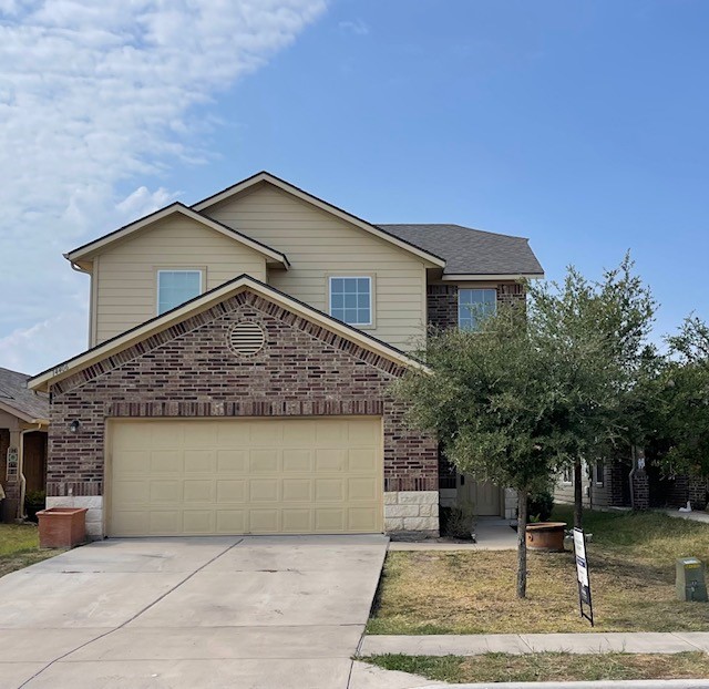 a front view of a house with garage