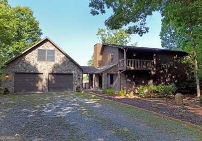 a front view of a house with a yard garage and outdoor seating