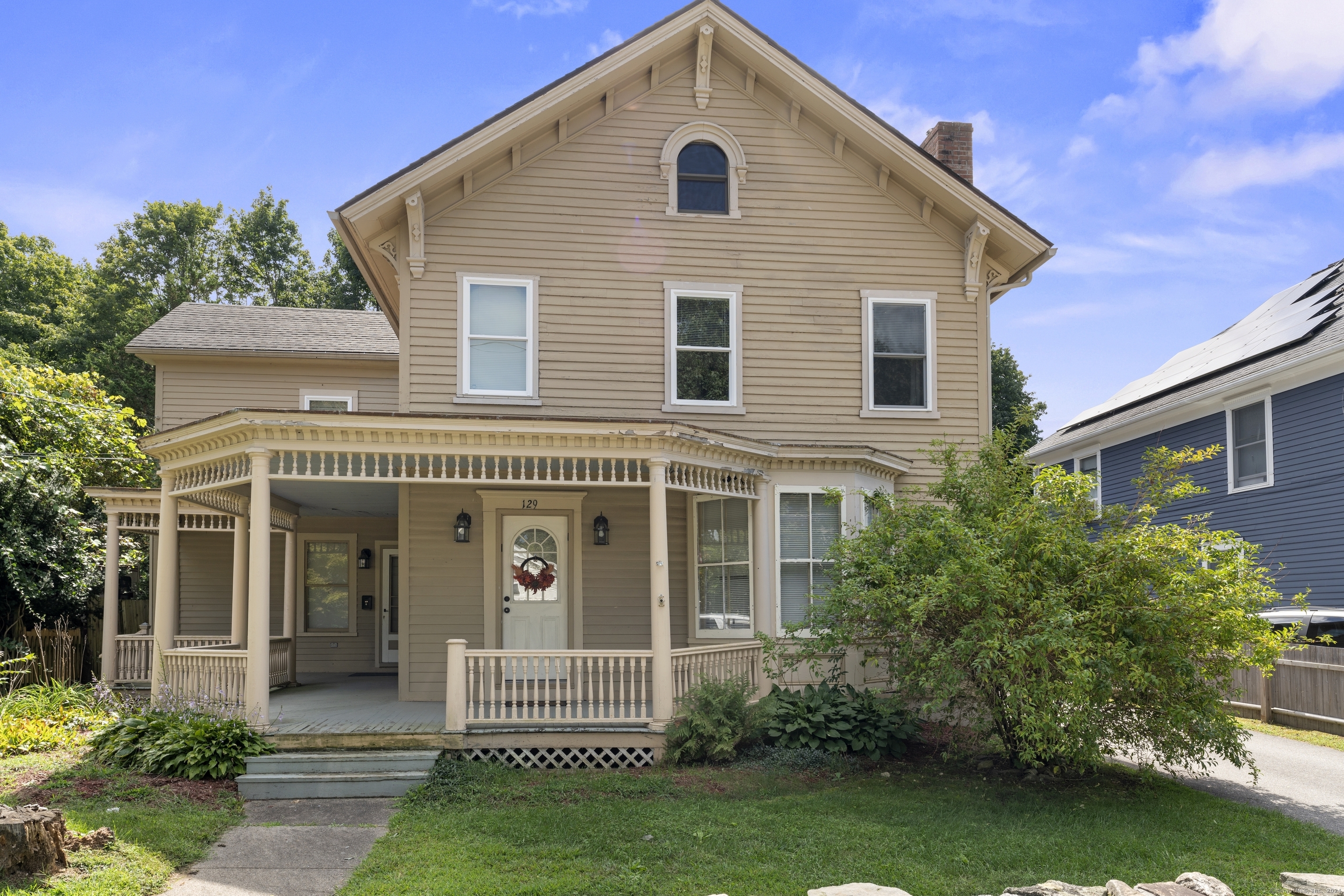 a front view of a house with a garden and plants