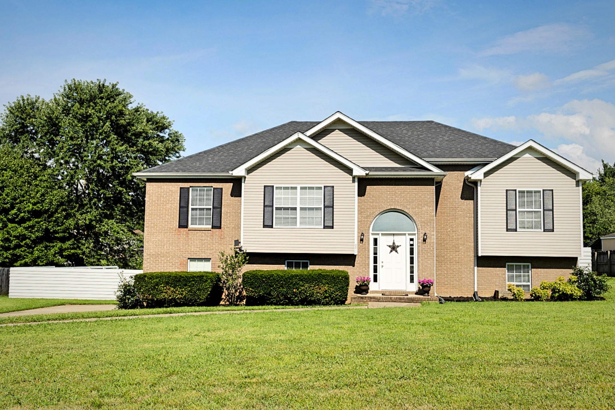 a front view of a house with a yard