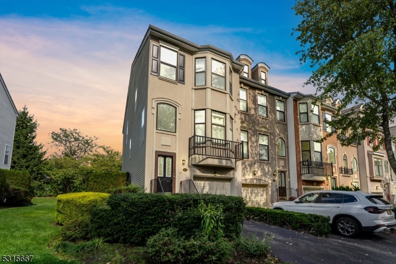 a front view of a residential apartment building with a yard