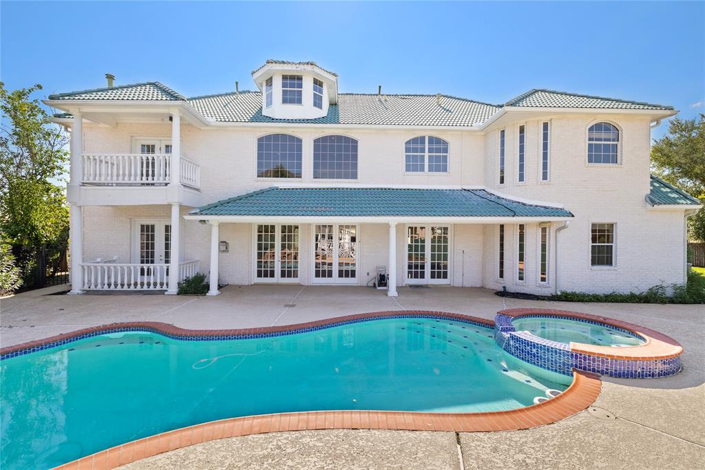 a front view of a house with swimming pool and porch