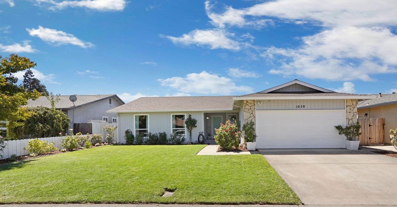 a view of house with yard and entertaining space