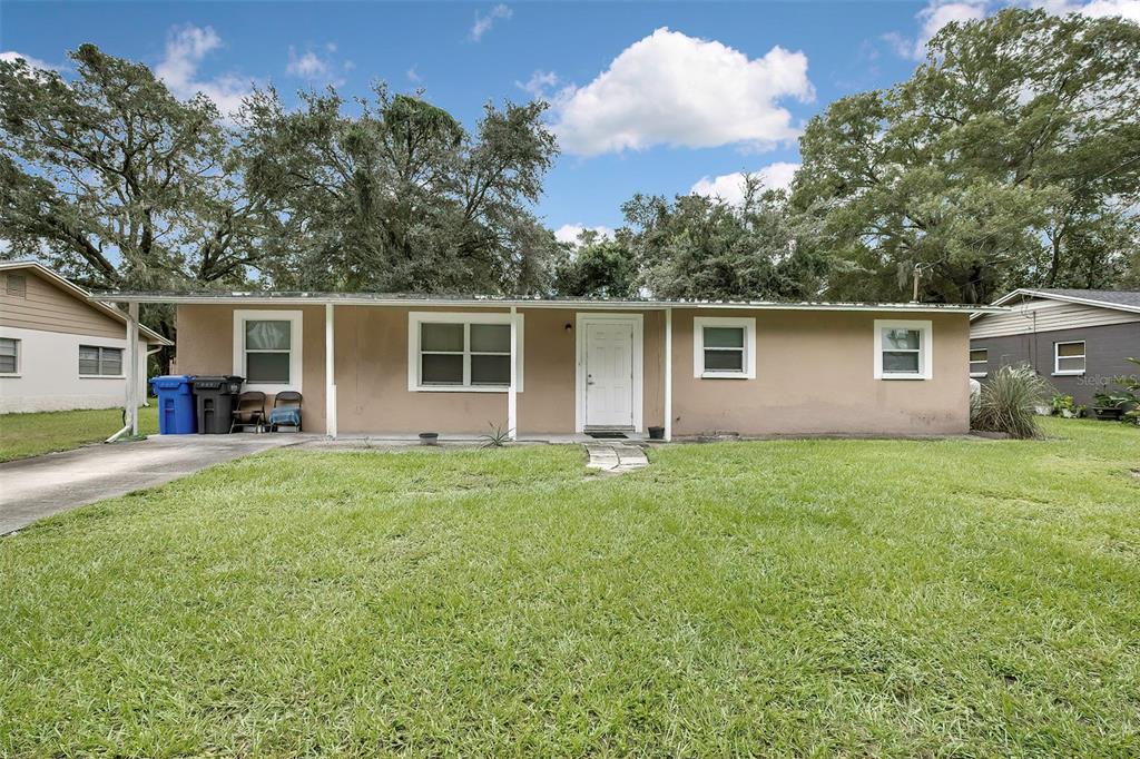 a front view of house with yard and green space