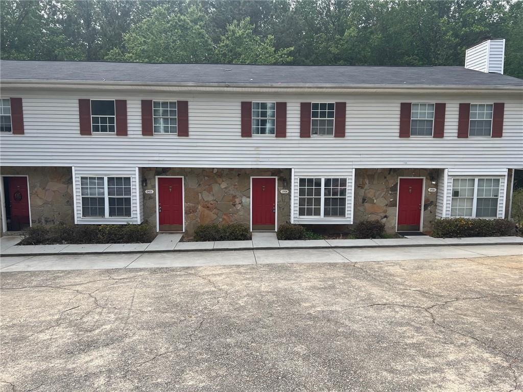 a front view of brick house with a yard