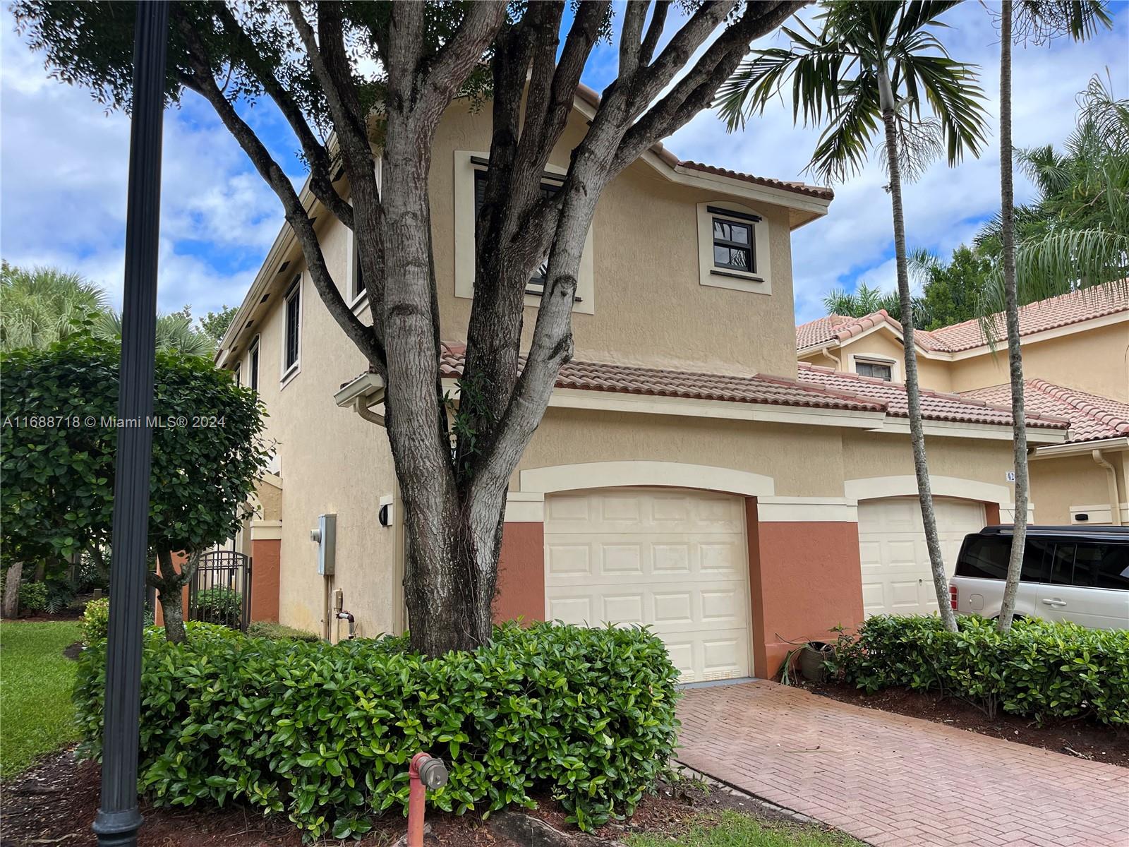 front view of a house with a trees