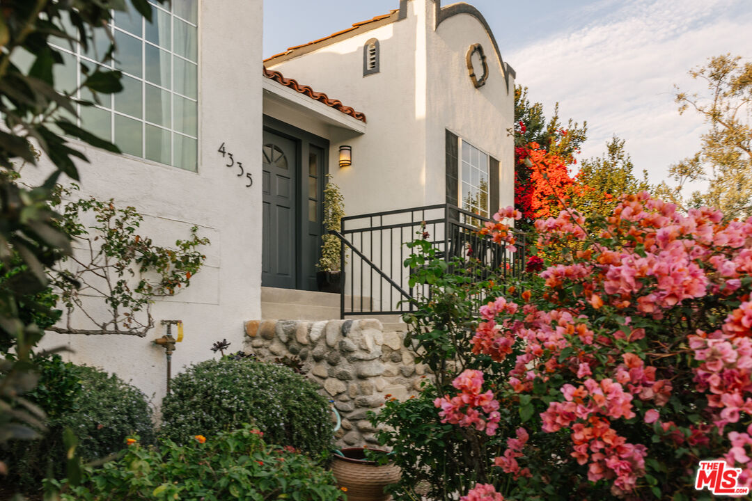 a view of a house with a flower garden