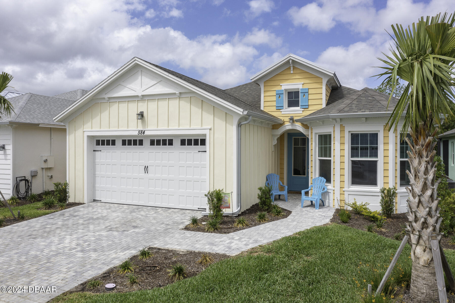 a front view of a house with a yard and garage