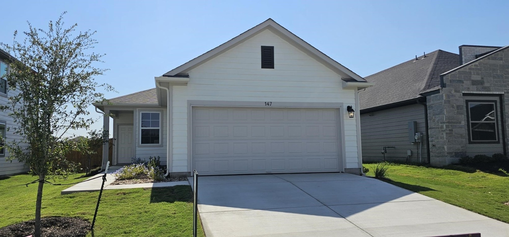 a front view of a house with garden