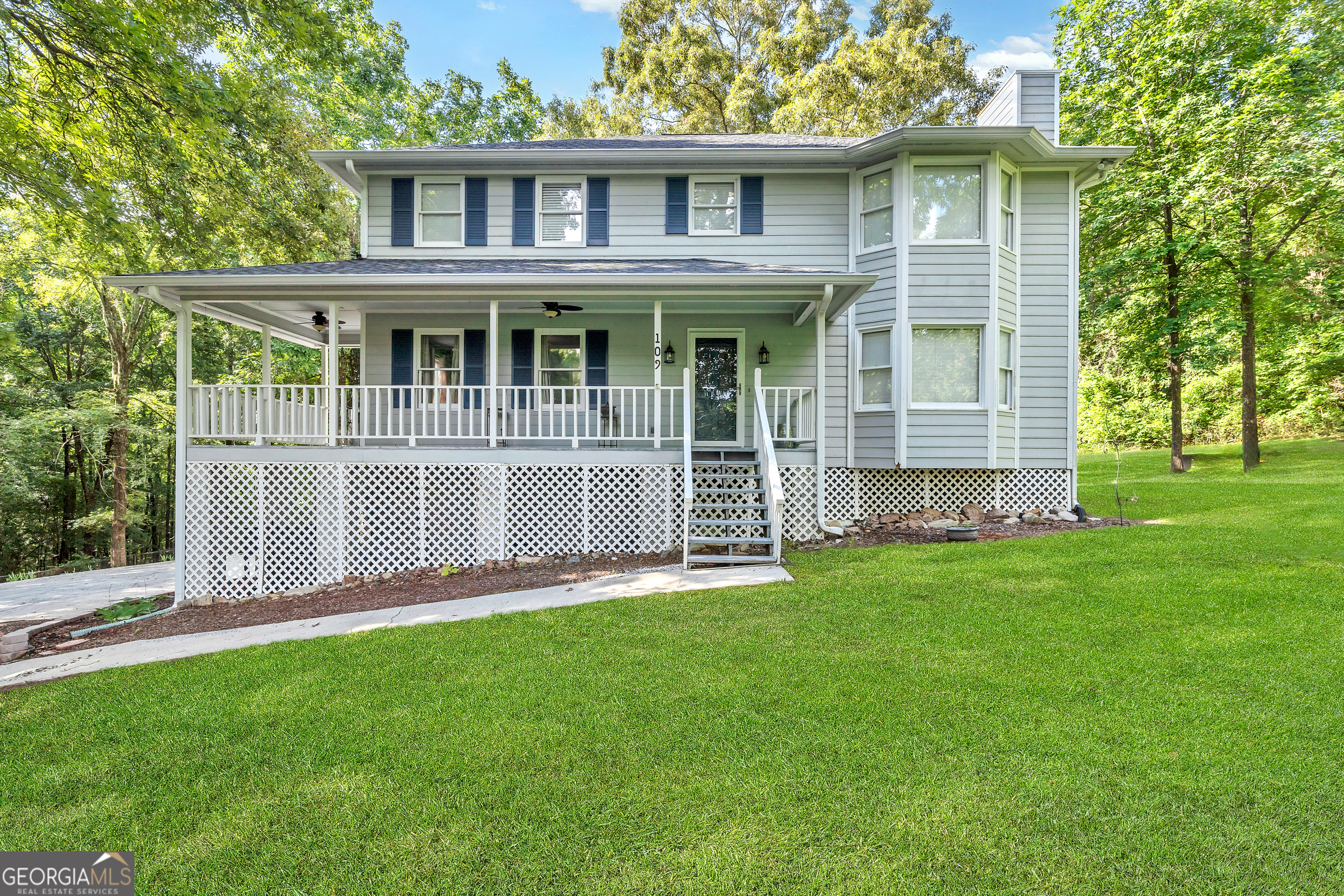 a view of a house with a yard and sitting area