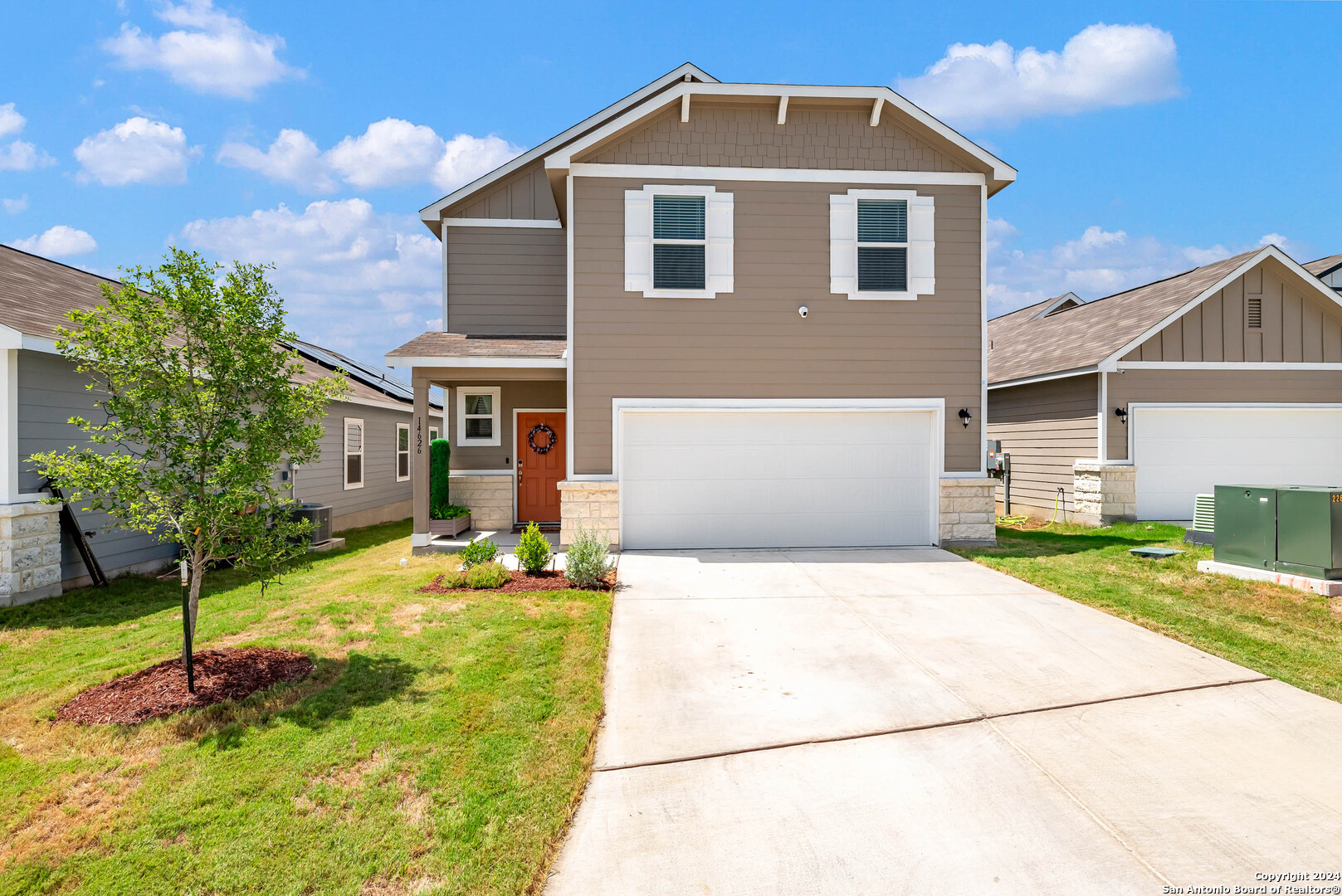 a front view of a house with a yard