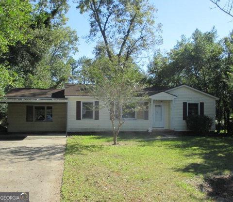 a house with trees in the background