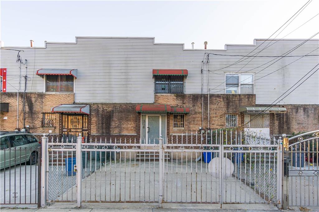 a view of a brick house with many windows