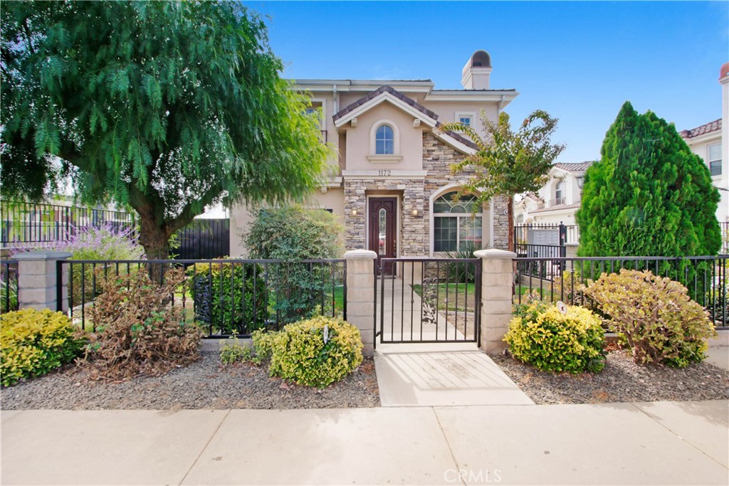 a front view of a house with a garden