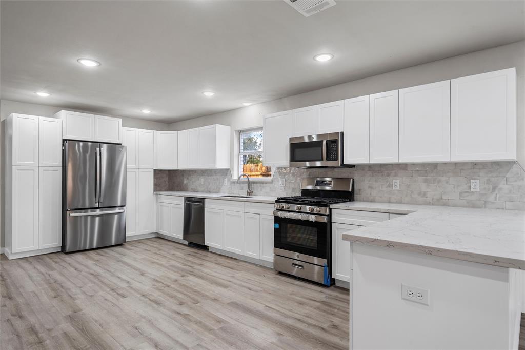 a kitchen with a refrigerator stove and microwave