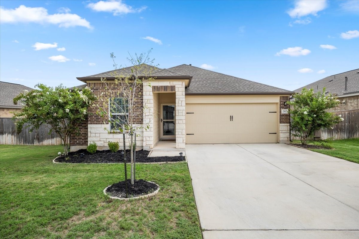 a front view of a house with a yard