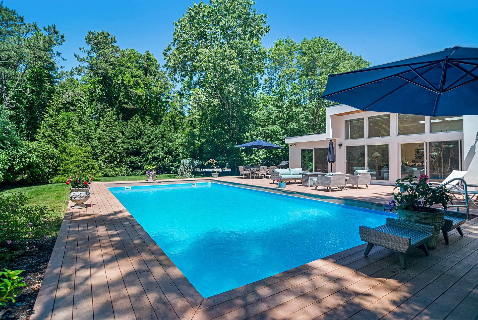 View of swimming pool with a wooden deck