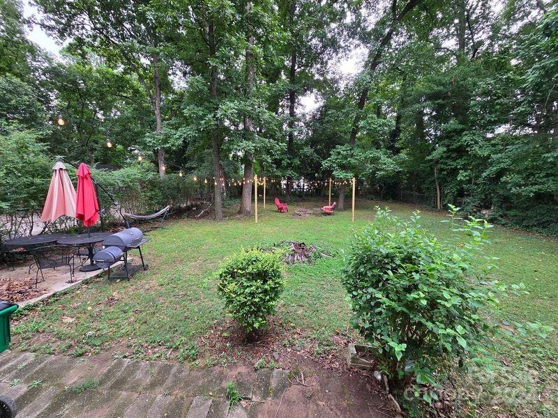 a view of a backyard with swimming pool