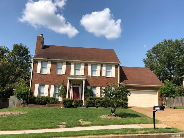 a front view of a house with a yard