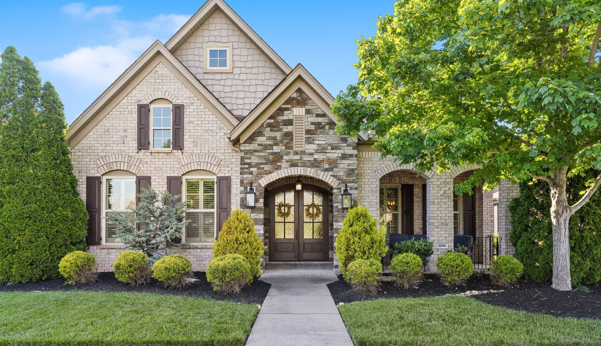 a front view of a house with garden