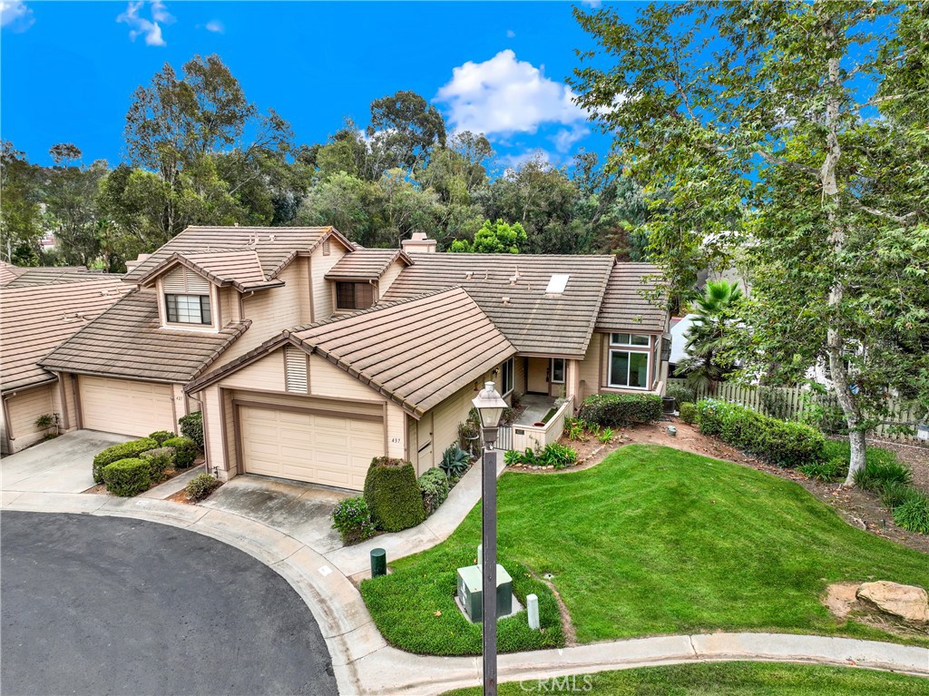 a aerial view of a house with a yard table and chairs