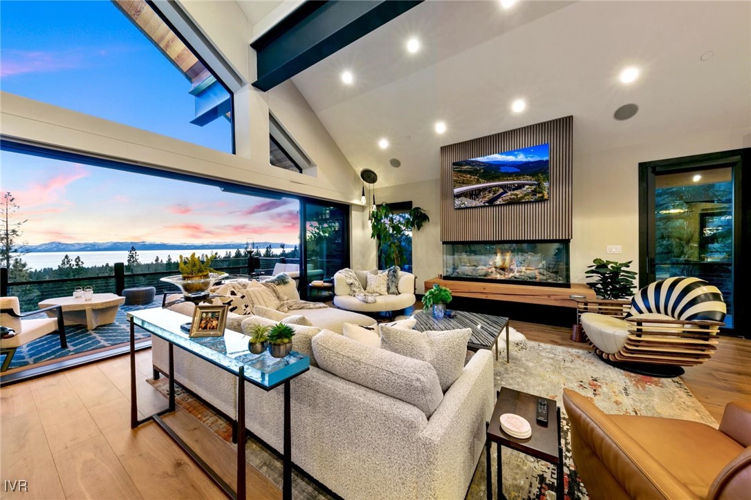 a living room with fireplace furniture and a floor to ceiling window