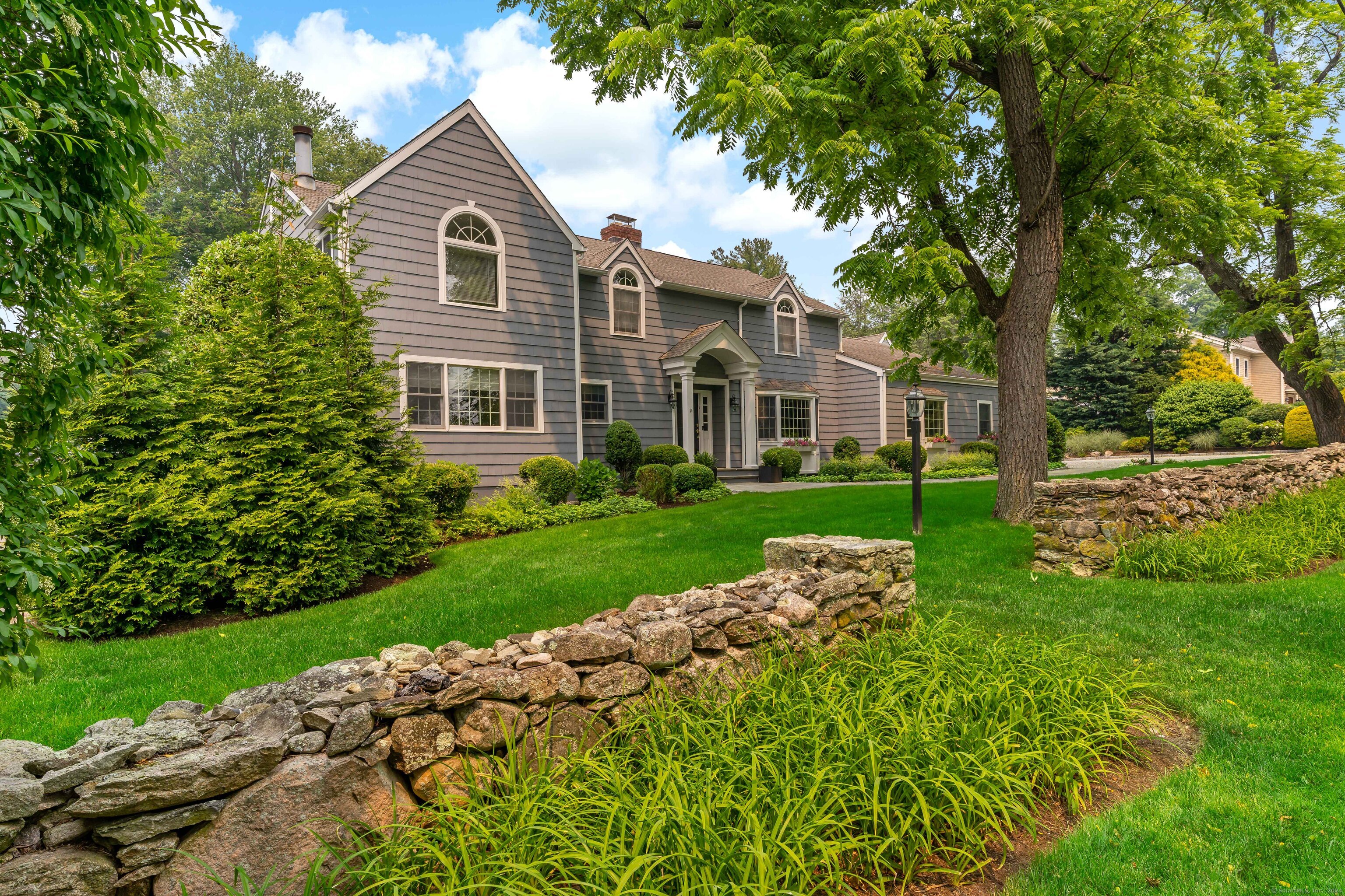 a front view of a house with garden