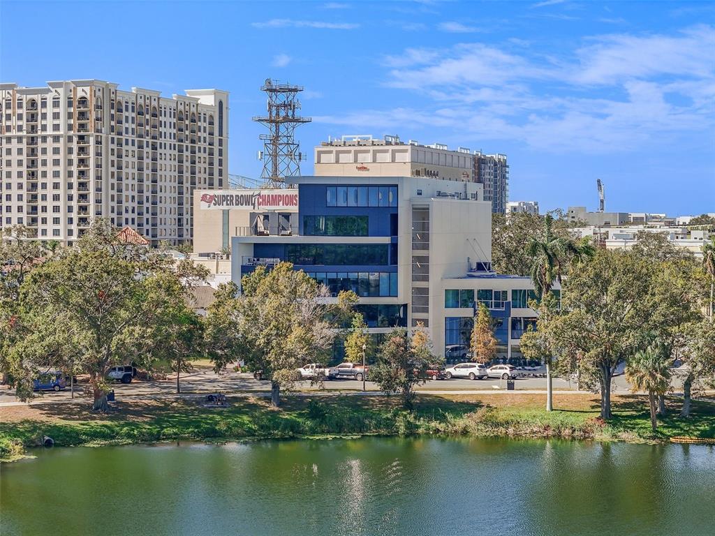 a view of a large building with a water yard and plants