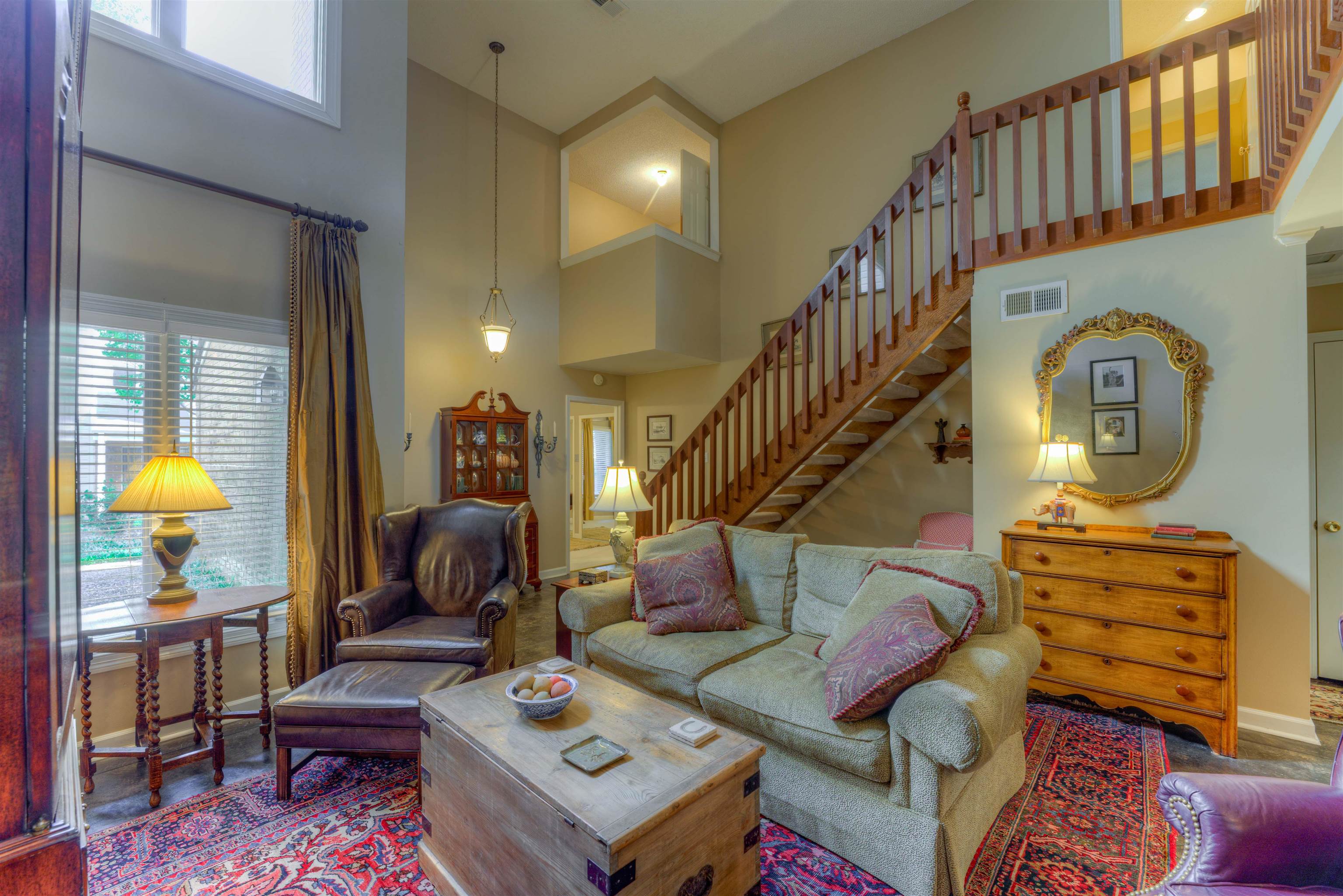 a living room with furniture a rug and a chandelier