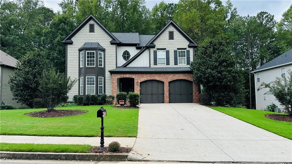 a front view of a house with a yard