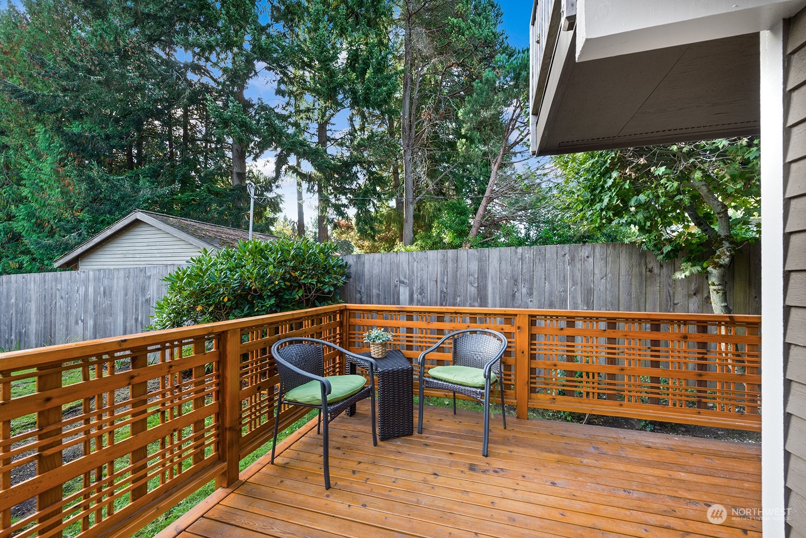 a backyard of a house with table and chairs