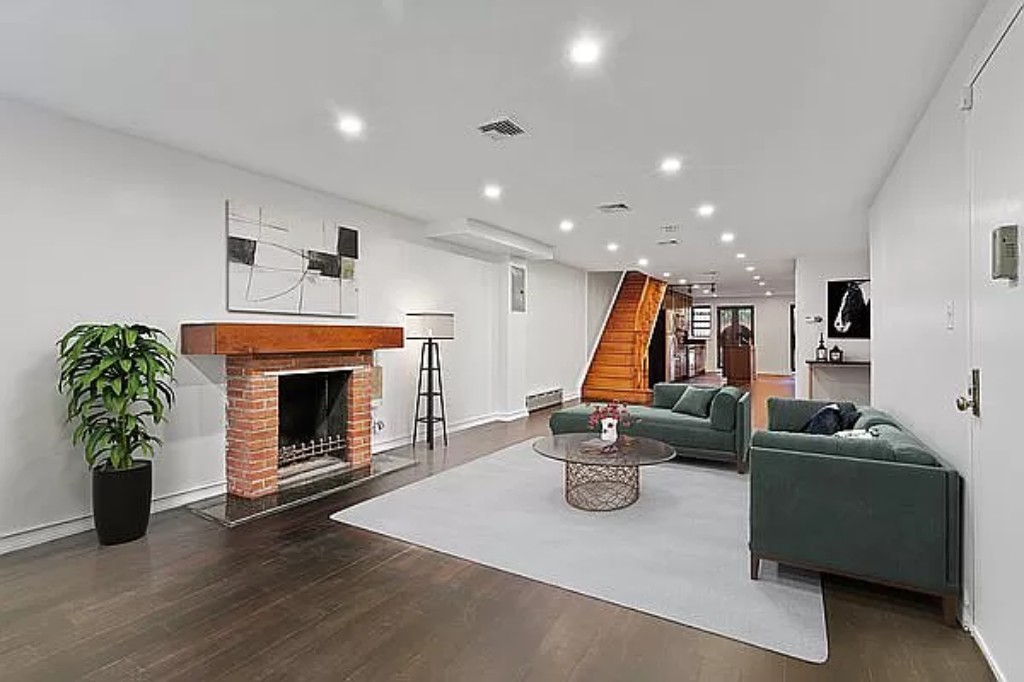 a living room with furniture a fireplace with wooden floor