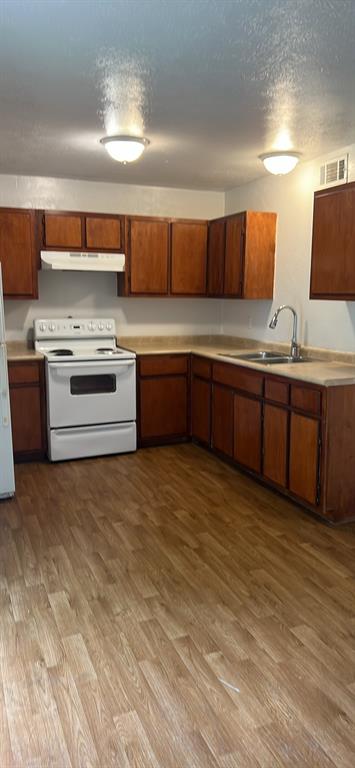 a kitchen with stainless steel appliances granite countertop a stove and a sink