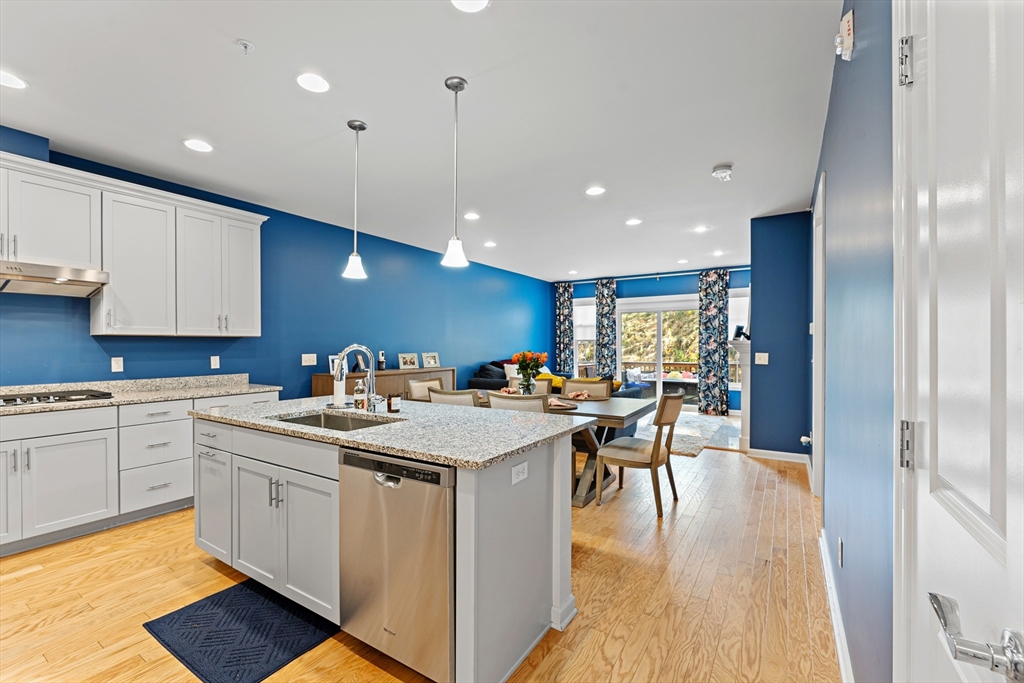 a kitchen with a sink microwave and cabinets