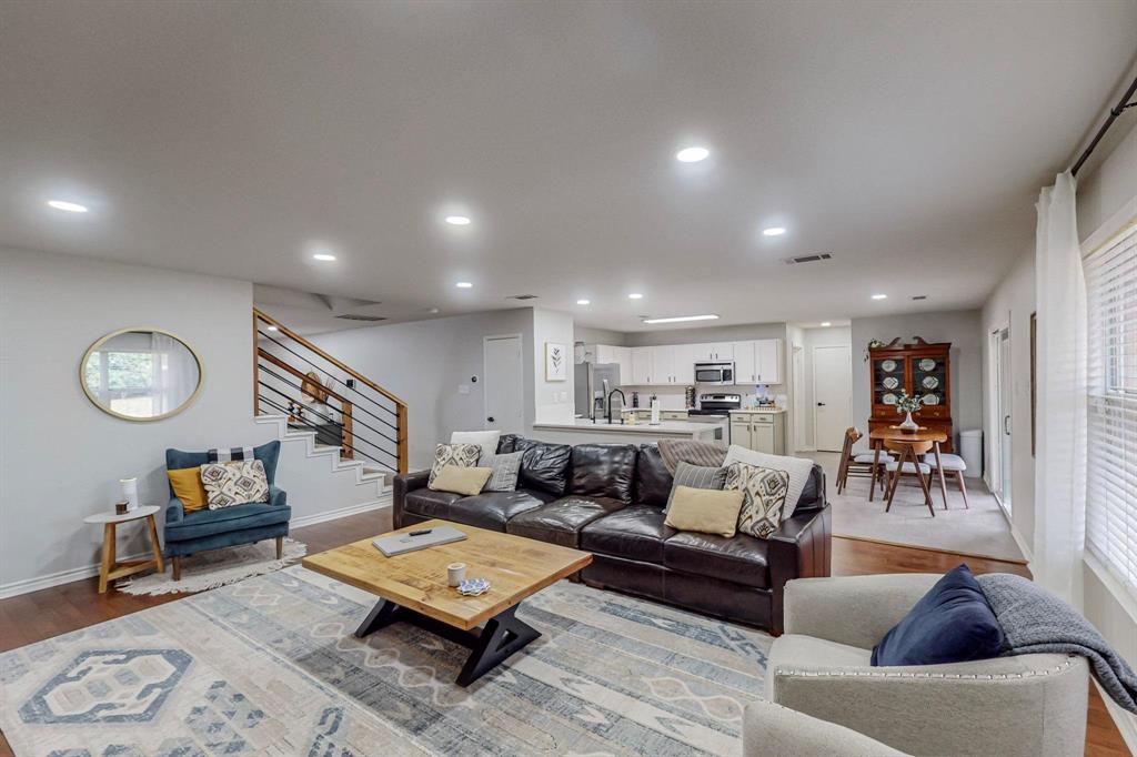 a living room with furniture kitchen view and a table