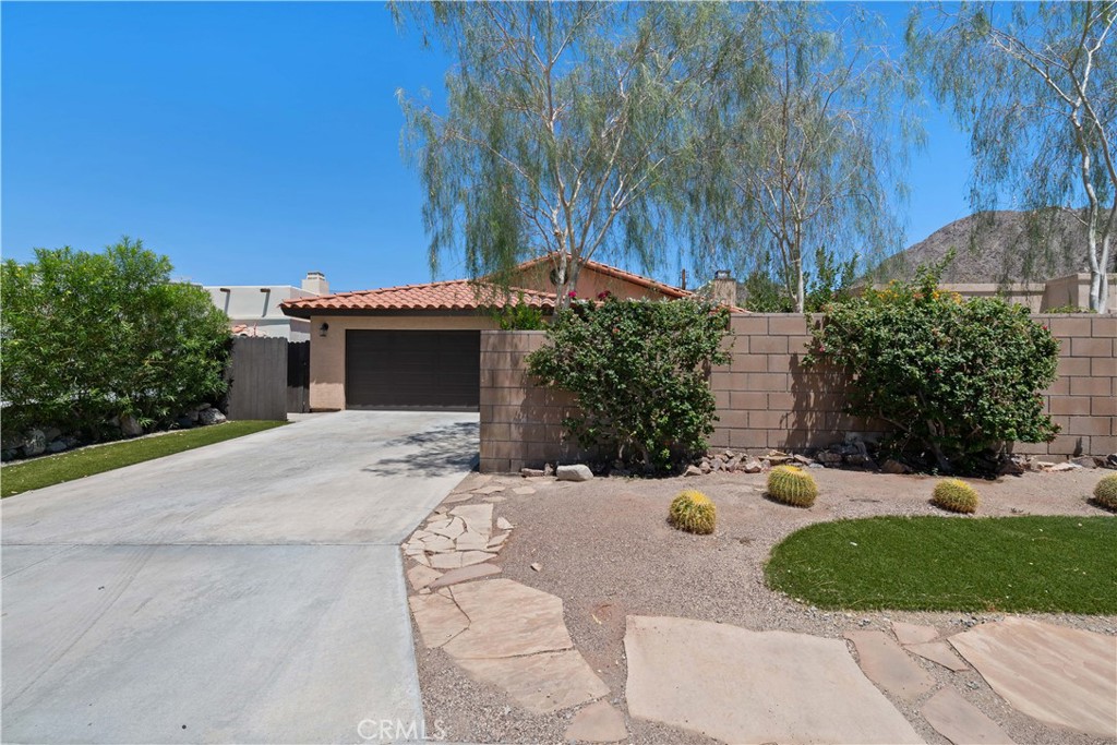 a view of a house with a yard and garage