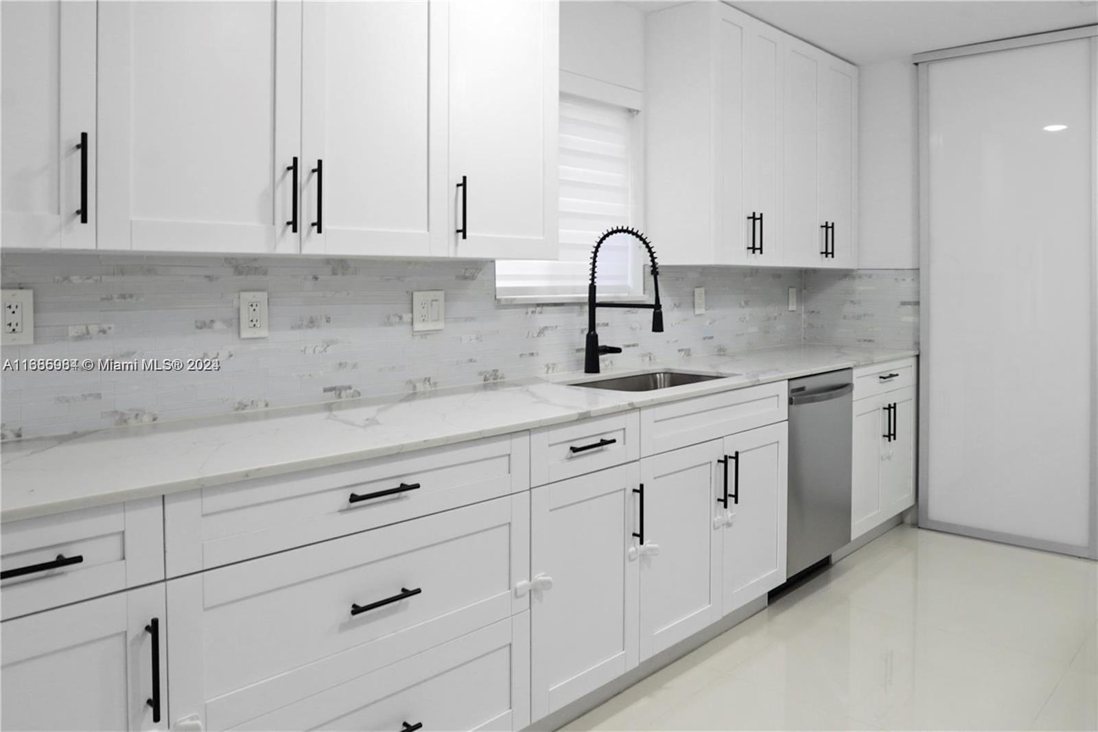 a kitchen with white cabinets and a sink