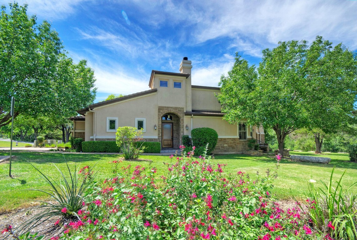 a view of a house with a yard and garden