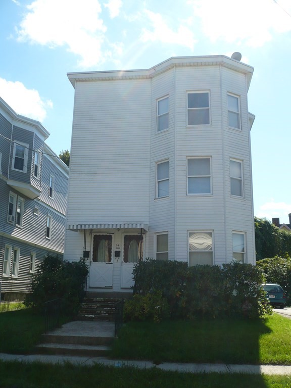 a front view of a building with garden