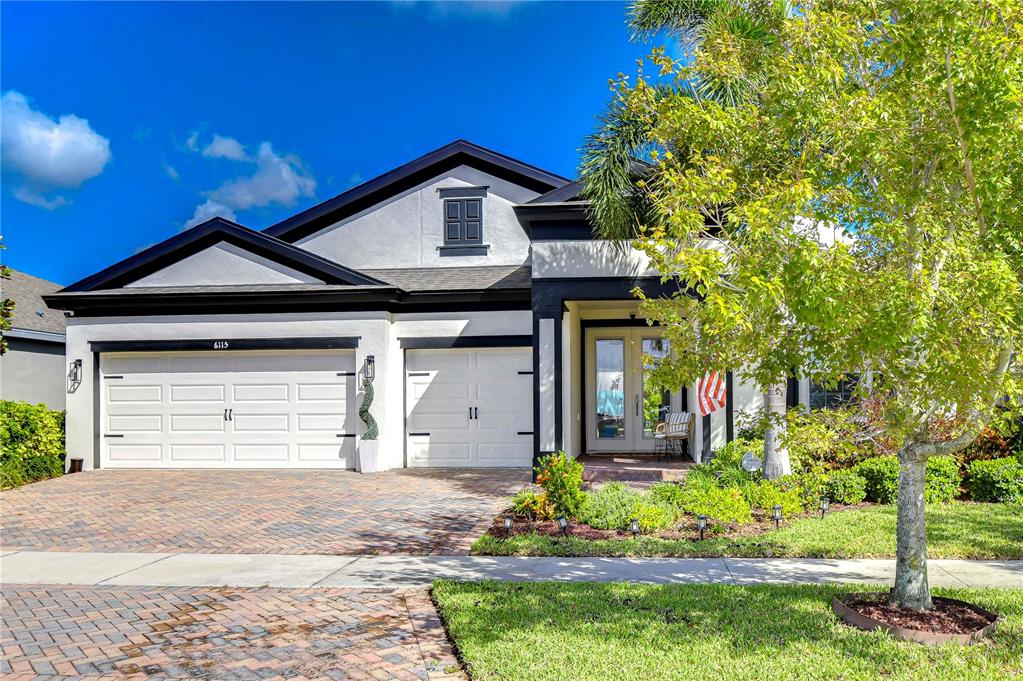 a front view of a house with a yard and garage