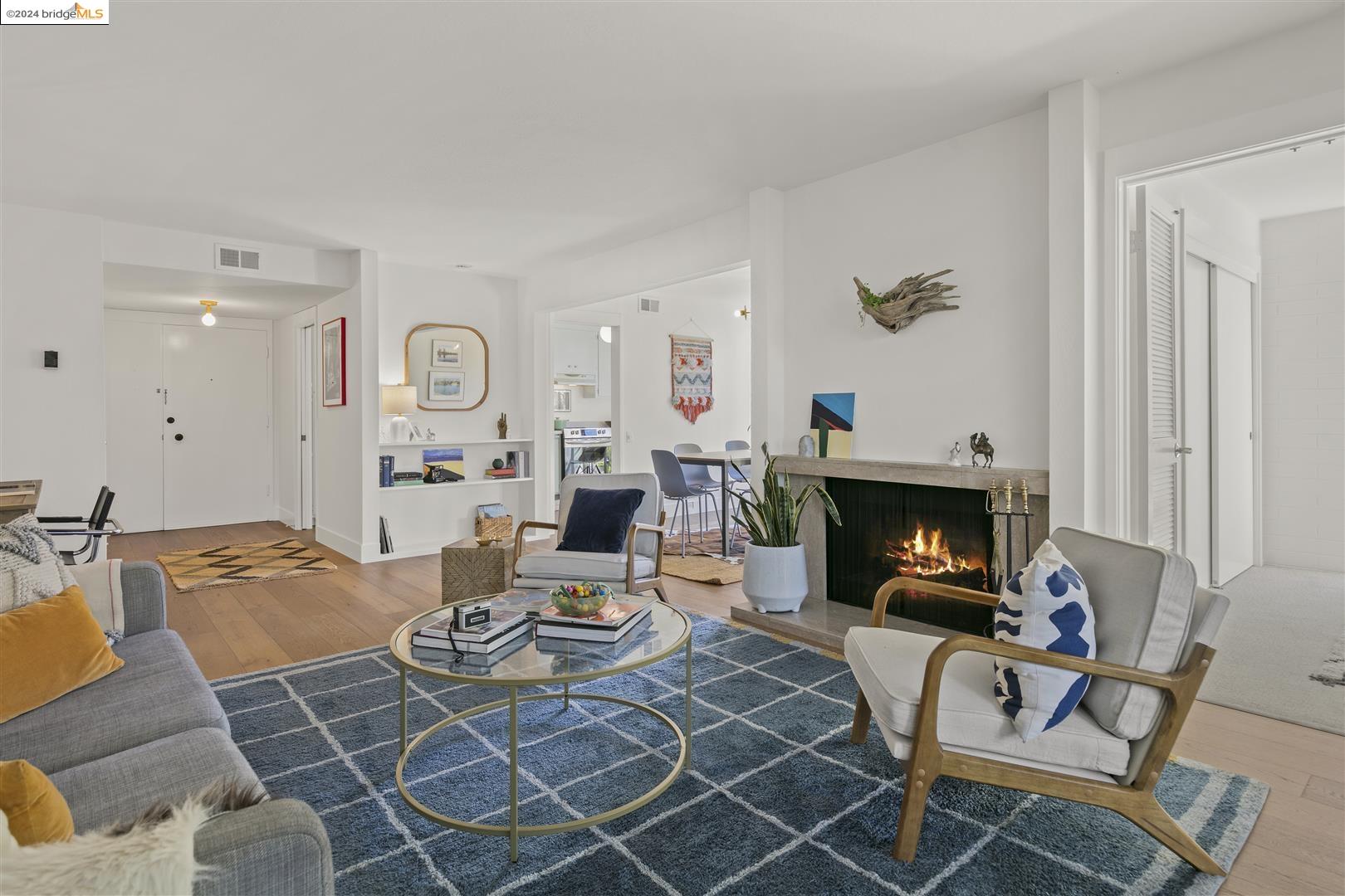 a living room with furniture a rug and a fireplace