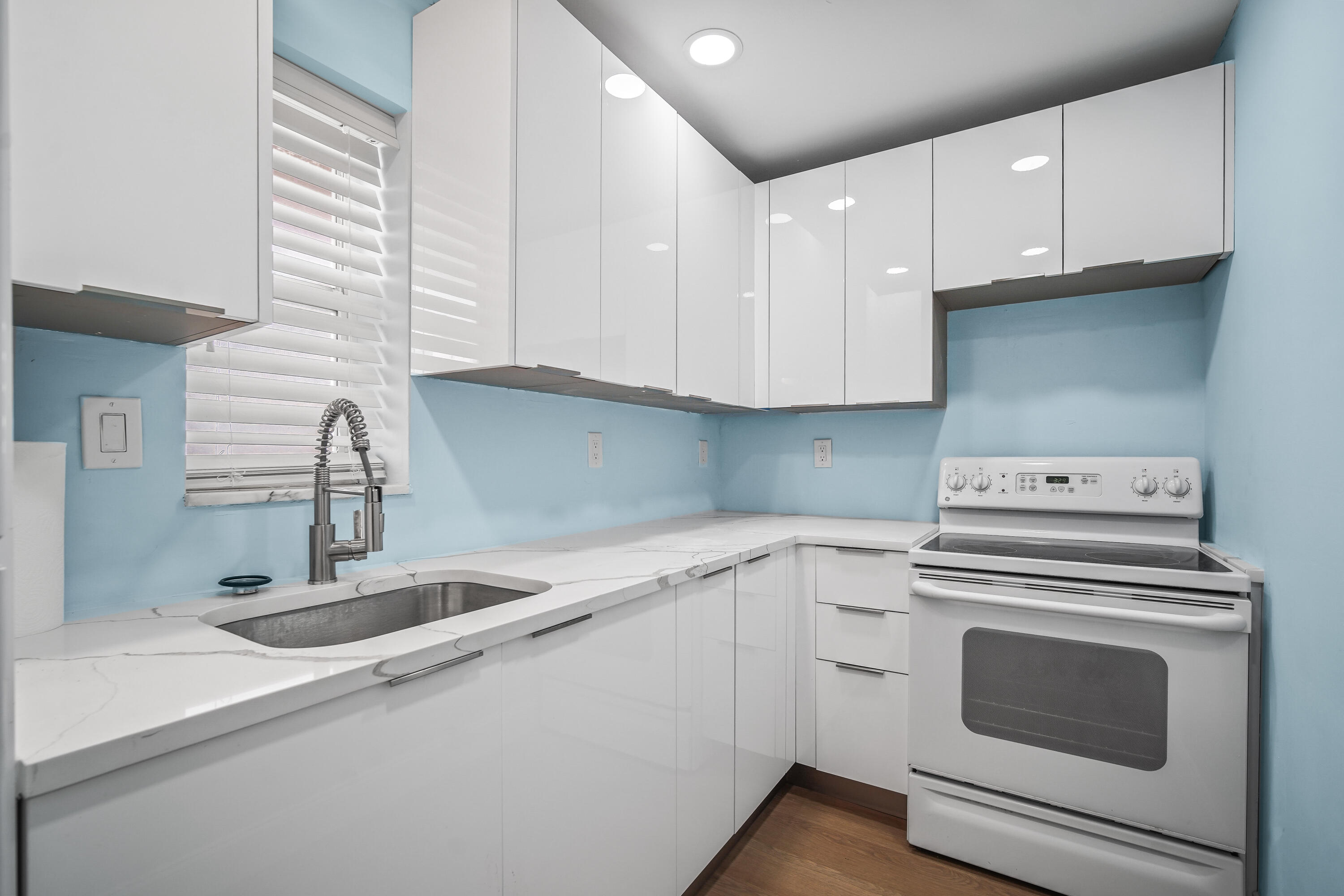 a kitchen with a sink stove and cabinets