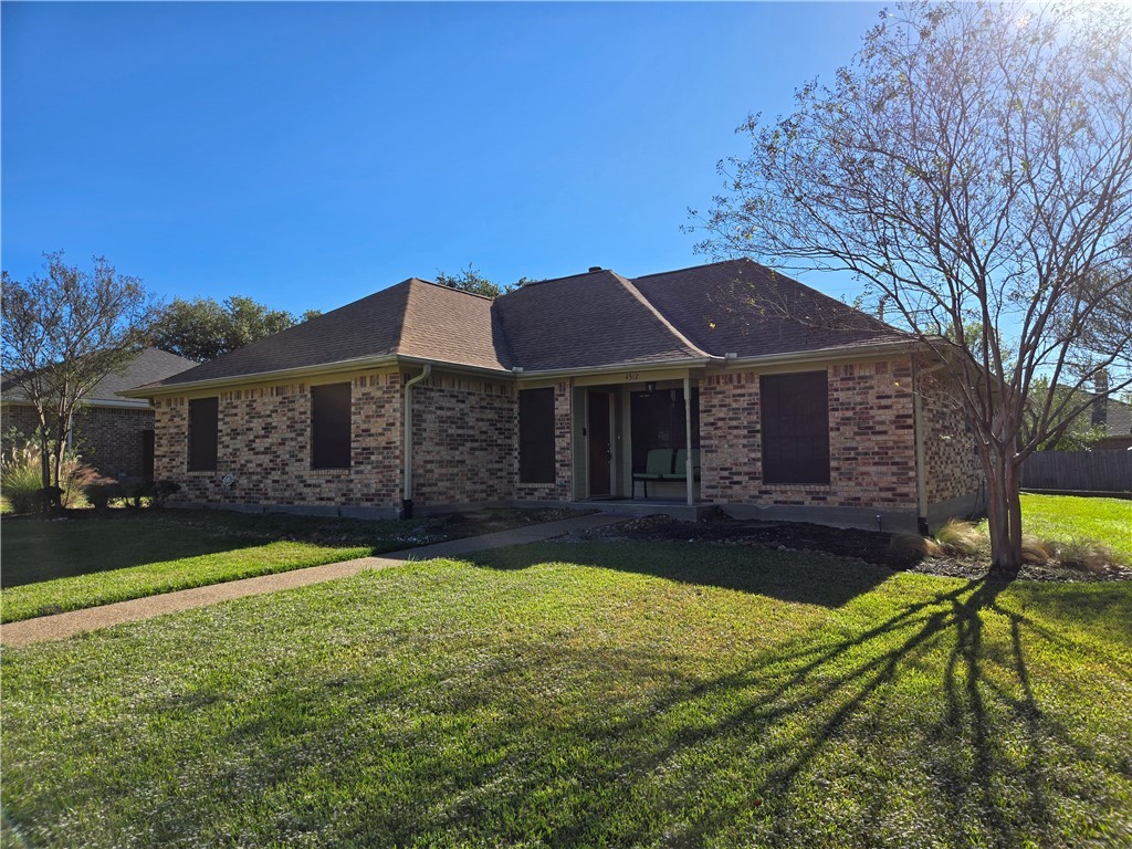 Ranch-style home featuring a front lawn